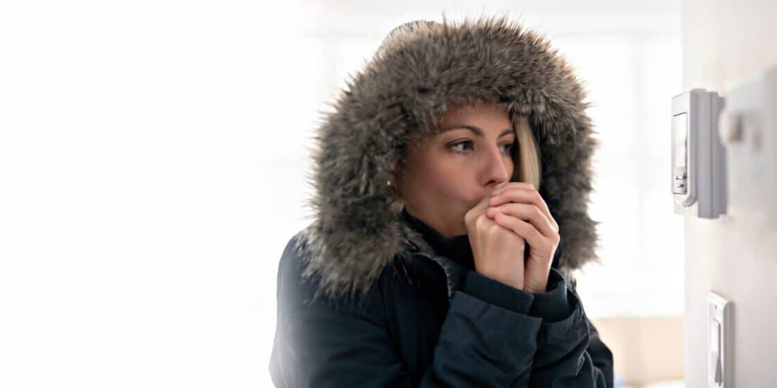 Woman With Warm Clothing Feeling The Cold Inside House