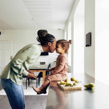 Loving mom and her little girl having a snack at home