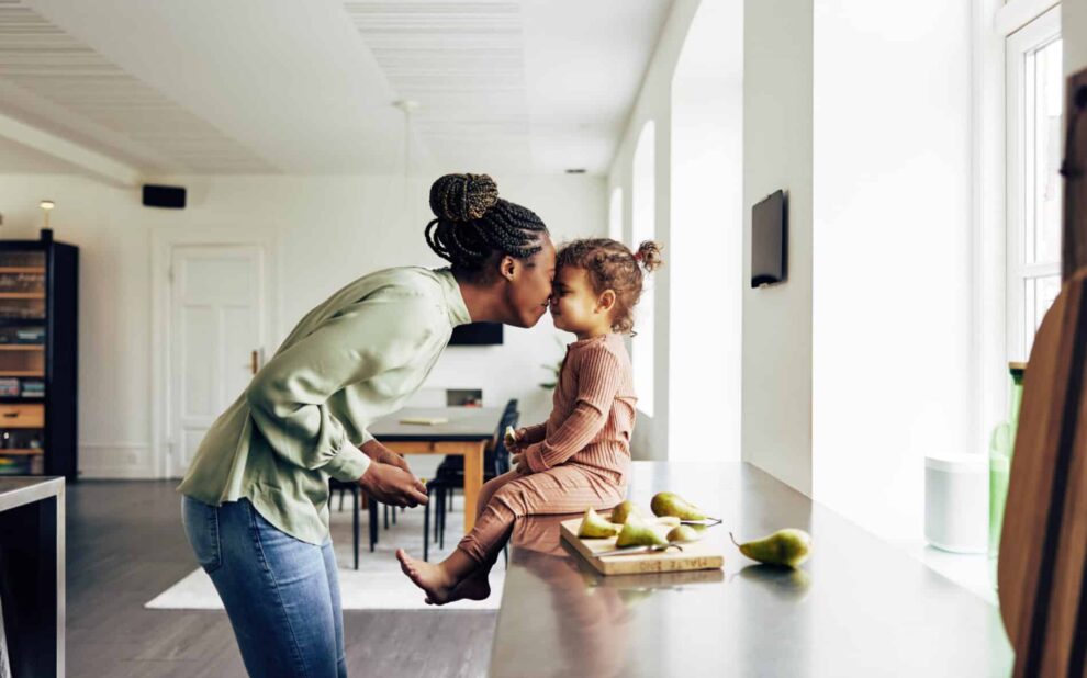Loving mom and her little girl having a snack at home